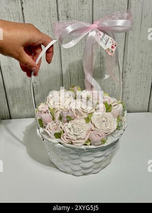 Guimauves dans un panier. Fleurs de guimauve. Guimauves maison. L'inscription sur l'étiquette en russe faite avec amour. Banque D'Images