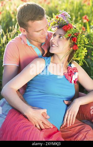 Belle Jeune femme enceinte dans quelques champs de coquelicots. Close up Banque D'Images