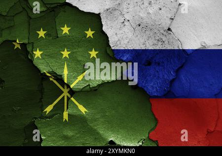 Drapeaux de la République d'Adygea et de la Russie peints sur le mur fissuré Banque D'Images