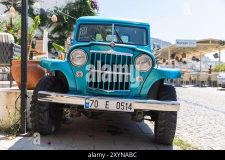 Kalkan, Turquie - 15 août 2024 : Blue pick-up stands parket sur le bord de la route par une journée ensoleillée, vue de face. Willys Jeep Truck est un camion fabriqué par Willys-O. Banque D'Images