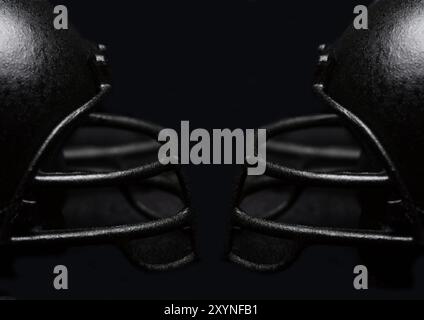 Casque de football noir protège-visage à la garde-visage sur un fond noir. Gros plan avec faible profondeur de champ. Concept de compétition. Banque D'Images