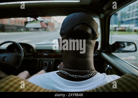 Vue arrière d'occiput masculin méconnaissable dans la voiture, homme assis sur le siège avant Banque D'Images