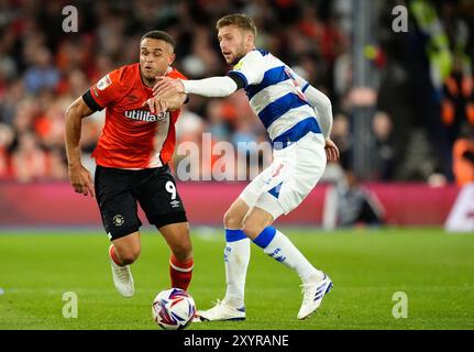 Carlton Morris de Luton Town en action contre Sam Field des Queens Park Rangers lors du Sky Bet Championship match à Kenilworth Road, Luton. Date de la photo : vendredi 30 août 2024. Banque D'Images