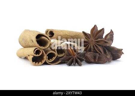 Empilez des bâtons de cannelle naturels et des étoiles d'anis avec une graine à l'intérieur isolé sur fond blanc Banque D'Images