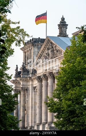 Le portail d'entrée du Reichstag à Berlin vu à travers quelques arbres Banque D'Images