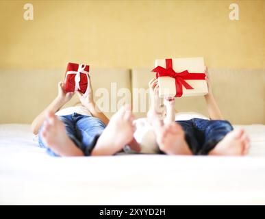 La famille doux au lit. Trois sœurs, Close up sur boîte-cadeau. Maison de vacances et de bonheur concept Banque D'Images