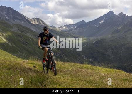 VTT sur une piste cyclable alpine, derrière Flueela Pass, Pischa, Graubuenden, Schwezi Banque D'Images