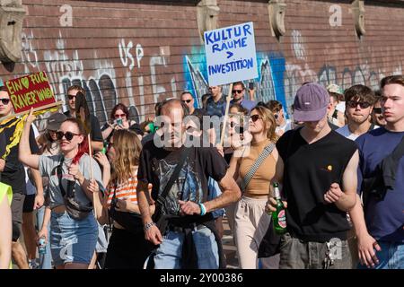 Hambourg, Allemagne. 31 août 2024. Un participant à la démo rave 'Reclaim Hamburg' tient une bannière avec l'inscription 'Kulturräume Investitionen'. Crédit : Georg Wendt/dpa/Alamy Live News Banque D'Images