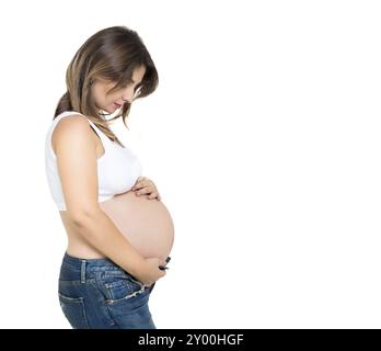 Jolie femme enceinte à l'intérieur sur fond blanc Banque D'Images