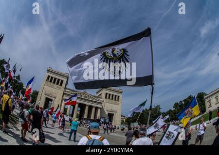 31 août 2024 : sous le nom de 'Grosser Treffen der 25 1 Bundesstaaten'', Reichsbuerger (ReichsbÃ¼rger, citoyens souverains, citoyens du Reich) s'est réuni sur la Koenigsplatz de Munich pour établir un réseau et nier la légitimité de la république allemande. Les Reichsbuerger ont été à l'origine banalisés et transformés en comédie dans les médias contre les avertissements de radicalisation par des experts jusqu'à ce qu'un raid à Georgesmund entraîne la mort d'un policier. L'affaire a également révélé Reichsbuerger dans la police et les structures étatiques mêmes dont ils nient la légitimité. À Munich, de nombreux Reichsbuerge connus Banque D'Images