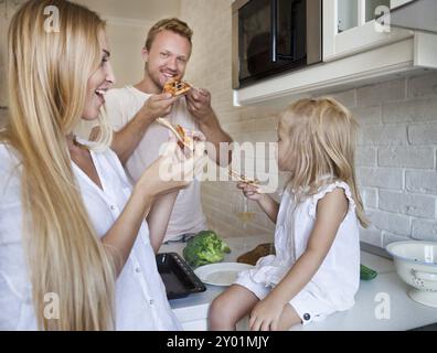 Happy Family eating pizza ensemble, à la maison Banque D'Images