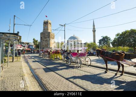 Antalya, Turquie, Novembeer 24, 2017 : calèches tirant des chevaux attendant les touristes devant la mosquée Tekeli Mehmet Pasa dans la vieille ville de Kaleici. Horizontal Banque D'Images