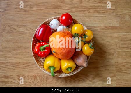 Panier, bol de fruits et légumes colorés sur une table en bois rustique Banque D'Images