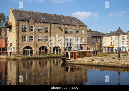 Le canal étroit mouillait le long d'anciens bâtiments de quai de canal sur le canal de Rochdale dans la ville de marché de Calder Valley West Yorkshire de Hebden Bridge Banque D'Images