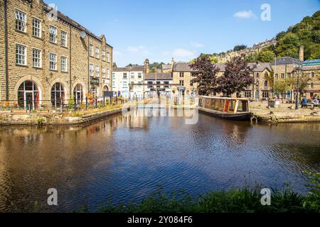 Le canal étroit mouillait le long d'anciens bâtiments de quai de canal sur le canal de Rochdale dans la ville de marché de Calder Valley West Yorkshire de Hebden Bridge Banque D'Images