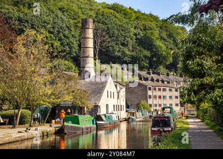 Les bateaux étroits de canal amarrés par l'ancien moulin Crossleys sur le canal de Rochdale dans la ville de marché de Calderdale Valley de Hebden Bridge West Yorkshire Angleterre Banque D'Images