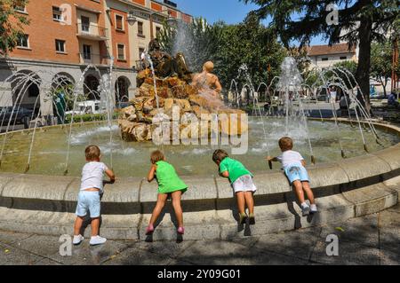 Quatre enfants jouant dans la fontaine allégorique à l'eau et à la terre dans la ville de Don Benito, sculptures urbaines en Espagne Banque D'Images