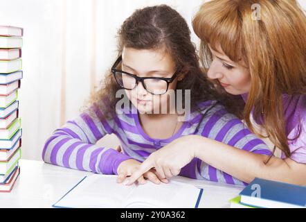 Petite fille avec et sa mère lisant le livre Banque D'Images