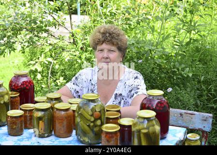 Femme au foyer mature avec une nourriture en conserve pour l'hiver Banque D'Images