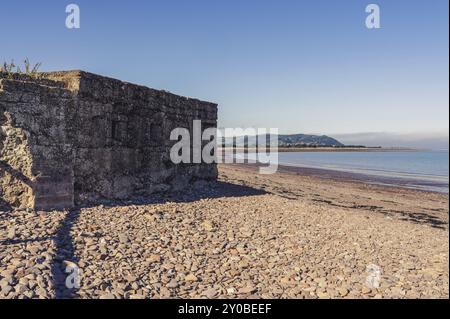 Un vieux bunker sur la plage à Blue Anchor, Somerset, Angleterre, Royaume-Uni, regardant le canal Bristol et Minehead en arrière-plan Banque D'Images