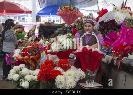 Bichkek, Kirghizistan, 2 octobre 2014 : une dame vendant des fleurs à Osh Bazar, en Asie Banque D'Images