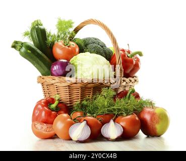 La composition avec des légumes crus et panier en osier isolated on white Banque D'Images