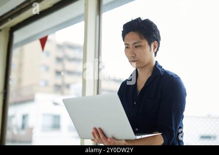 Un homme utilisant l'ordinateur portable Banque D'Images