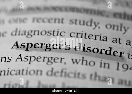 Gros plan du mot « syndrome d'Asperger » du manuel de psychologie Banque D'Images