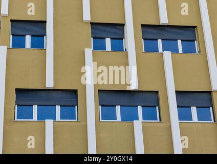 Cadres de verre de fenêtre du nouveau bâtiment en cours de développement : extérieur de mur beige Banque D'Images