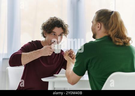 Un couple joyeux partage un moment d'amour autour d'un café dans leur maison confortable. Banque D'Images