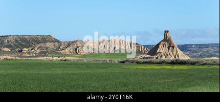 Une formation rocheuse unique s'élève dans un paysage vert et sec sous un ciel clair, formation rocheuse sous un ciel bleu, roche Castildetierra sur la droite, Barde Banque D'Images