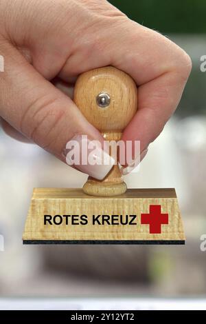 Symbole photo, main de femme avec timbre, inscription : Croix-Rouge allemande, logo, studio Banque D'Images