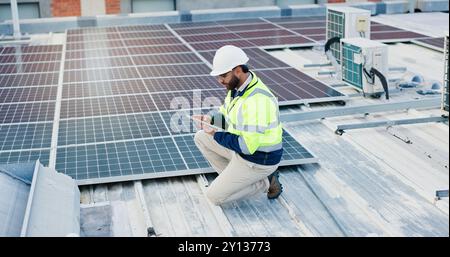 Technicien, homme et tablette pour panneaux solaires, économie d'énergie et électricité ou chauffage de grille écologique sur le toit. Ingénierie, technologie numérique Banque D'Images