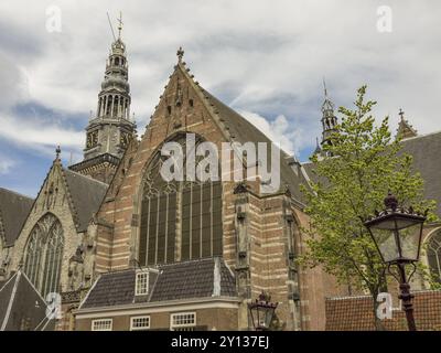 Église historique avec une haute tour et de grandes fenêtres, entourée d'arbres et de nuages dans le ciel, Amsterdam, pays-Bas Banque D'Images