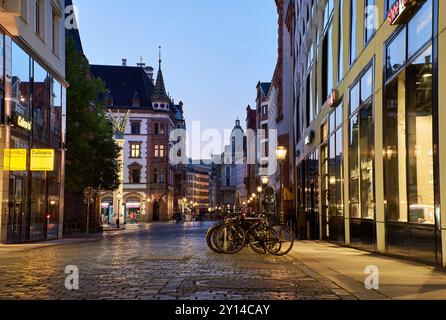 Old Grimmaische Strasse à Leipzig, Saxe au crépuscule est l'une des rues commerçantes du centre-ville allemand. Soirée sur une avenue pavée historique Banque D'Images