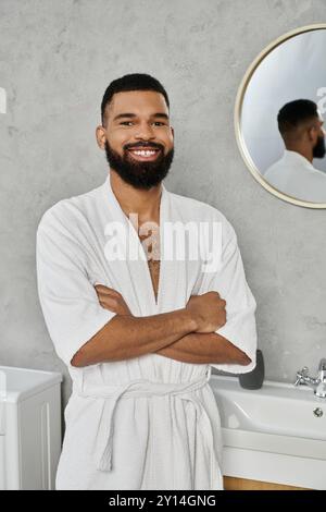 Homme souriant profitant du temps libre dans un environnement de salle de bains élégant et serein. Banque D'Images