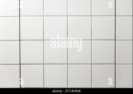 Carreaux carrés blancs sur le mur de la salle de bain comme texture ou fond Banque D'Images