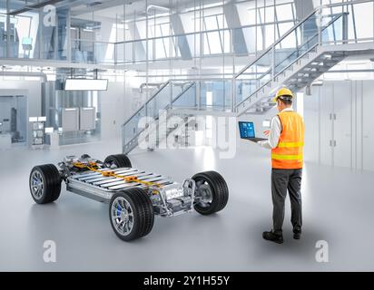 Ingénieur ou technicien asiatique travaillent avec la voiture ev en usine Banque D'Images