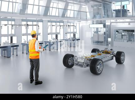 Ingénieur ou technicien asiatique travaillent avec la voiture ev en usine Banque D'Images