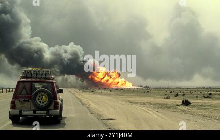 Première Guerre du Golfe : 7 mars 1991 flammes bouillantes et flot de fumée provenant de puits de pétrole sabotés dans le champ pétrolier de Burgan, au sud de Koweït City. Banque D'Images