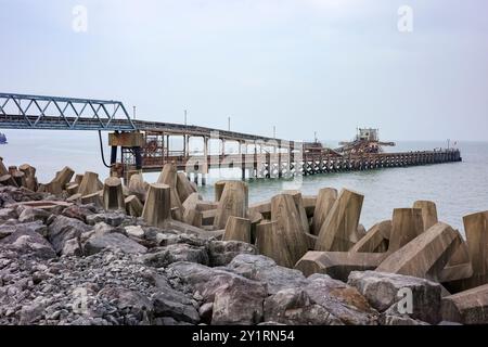 Colwyn Bay, Nord du pays de Galles, Royaume-Uni, 09-08-2024. Longue jetée industrielle s'étendant dans la mer par un jour nuageux. Banque D'Images