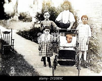 Photographie vintage de 5 enfants en plein air, dont un nourrisson dans une poussette Allwin Baby, 1919, États-Unis. Banque D'Images