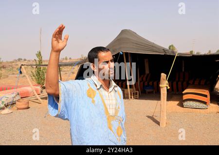 Camp nomade avec dromadaires et chauffeur de chameaux dans la campagne désertique près du moyen Atlas au Maroc. Maroc, Afrique du Nord. Crédit : photo par Hug Banque D'Images