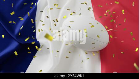 Image de confettis sur ballon de rugby blanc et drapeau de la france Banque D'Images