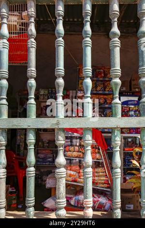 Gros plan d'une fenêtre en treillis à la lumière du soleil avec un fond coloré, dans la vieille ville, Carthagène, Colombie, Amérique du Sud Banque D'Images