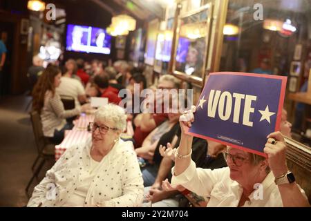 Bloomington, États-Unis. 10 septembre 2024. BLOOMINGTON, INDIANA - 10 SEPTEMBRE : les membres du public réagissent alors que le candidat républicain Donald Trump et le candidat démocrate Kamala Harris débattent sur CNN le 10 septembre 2024 à Bloomington, Indiana. Après avoir remporté la nomination du Parti démocrate suite à la décision du président Joe Biden de quitter la course, candidat démocrate à la présidence, le vice-président américain Kamala Harris affronte l'ancien président Donald Trump, candidat républicain à la présidence. (Vidéo par Credit : Jeremy Hogan/Alamy Live News Banque D'Images