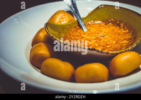 Célèbre crabe Chili de Singapour transformé en délicieuse trempette chaude. Servi avec un choix de petits pains chinois. Banque D'Images