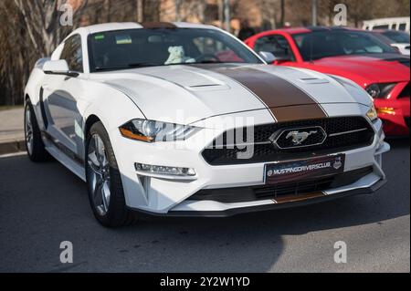 Une spectaculaire et moderne voiture de sport américaine Ford Mustang de sixième génération avec le restyling 2018 ou faclift en blanc avec une bande brune Banque D'Images