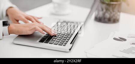 Fille méconnaissable travaillant sur son ordinateur portable au bureau Banque D'Images