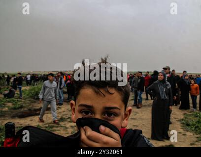 Gaza, Palestine, 30 mars 2019. Des manifestants palestiniens affrontent des soldats israéliens à Abu Safiya, à l'est de la ville de Jabaliya, dans le nord de la bande de Gaza, au cours de la manifestation de la Grande Marche du retour de cette semaine, avec le chef du bureau politique du Hamas, Ismail Haniyeh, faisant une apparition sur le site d'Abu Safiya. Des milliers de Palestiniens se sont rassemblés sur différents sites le long des frontières orientales de la bande de Gaza pour participer à la marche hebdomadaire visant à briser le siège israélien en cours et à marquer la Journée de la terre et le premier anniversaire de la Grande Marche du retour, selon le mini palestinien Banque D'Images